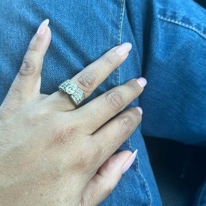 Diamond ring. Natural pear center stone/20 princess cut diamonds on each side.